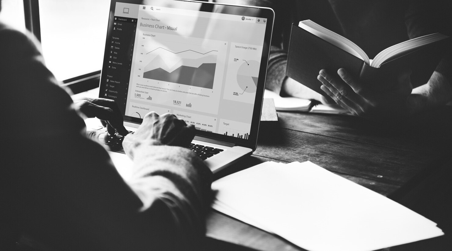 TechUp engineer monitoring application performance on laptop